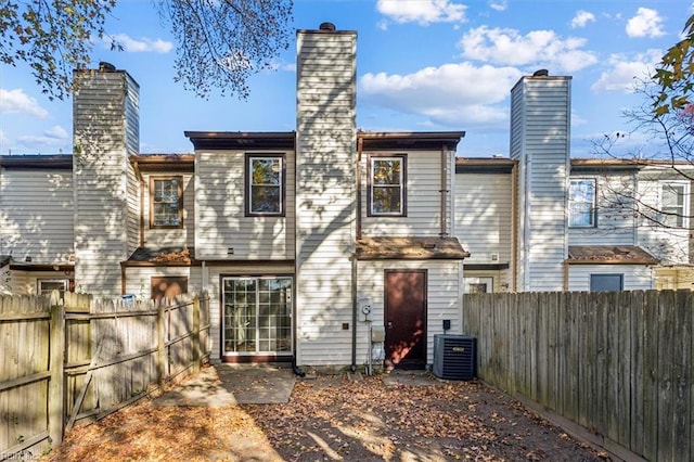 rear view of property featuring central air condition unit