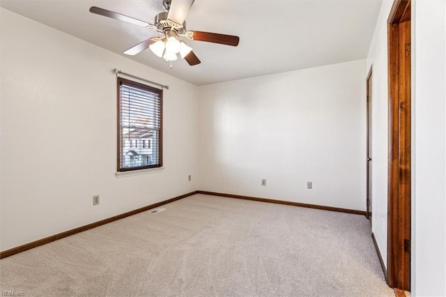 spare room with light carpet and ceiling fan