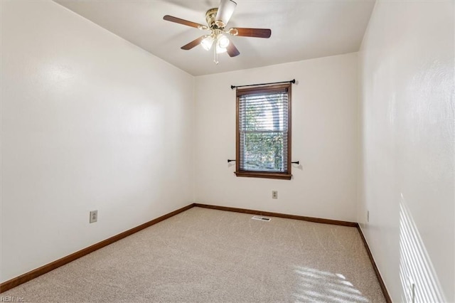 carpeted spare room with ceiling fan