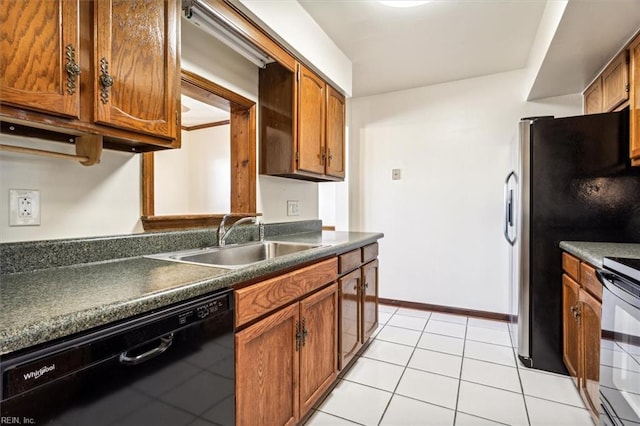 kitchen featuring stainless steel refrigerator, dishwasher, sink, light tile patterned floors, and electric stove