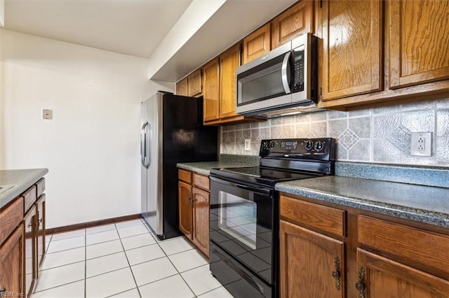 kitchen featuring stainless steel appliances, decorative backsplash, and light tile patterned floors