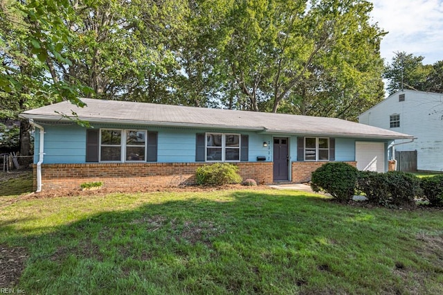 ranch-style house with a garage and a front lawn