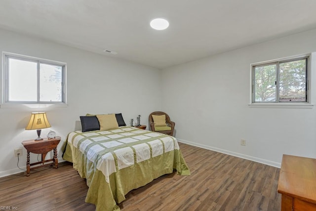 bedroom with dark wood-type flooring