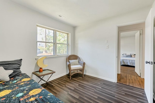 bedroom with dark hardwood / wood-style floors