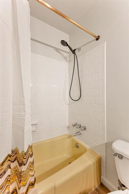 bathroom with shower / bath combination with curtain and toilet