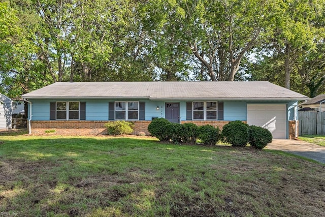 ranch-style home featuring a garage and a front lawn