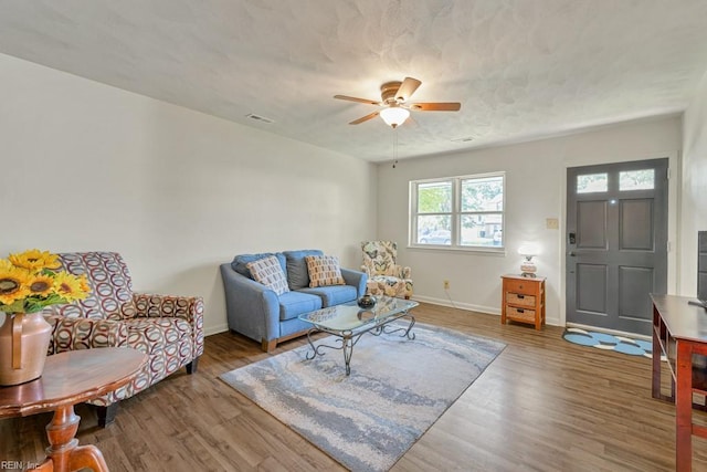 living room featuring ceiling fan and wood-type flooring