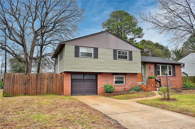 tri-level home featuring a garage and a front lawn