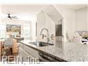 kitchen featuring sink and light stone countertops