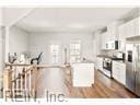 kitchen with white cabinetry, stainless steel fridge, and dark wood-type flooring