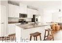 kitchen featuring white cabinetry and a kitchen bar