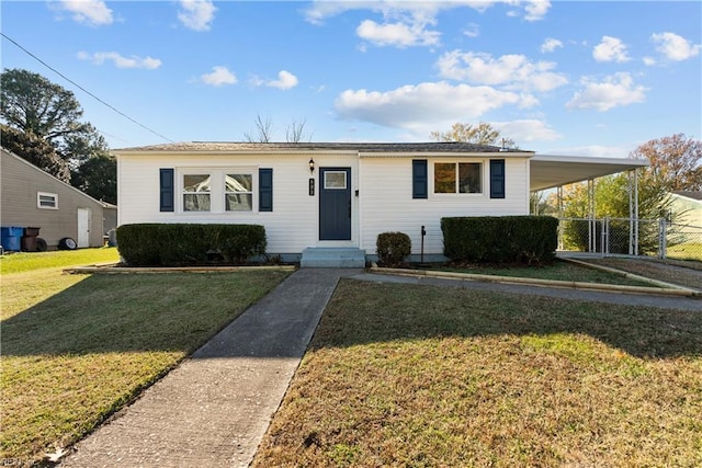 view of front of house with a carport and a front yard