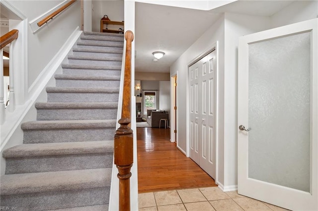 staircase with tile patterned floors