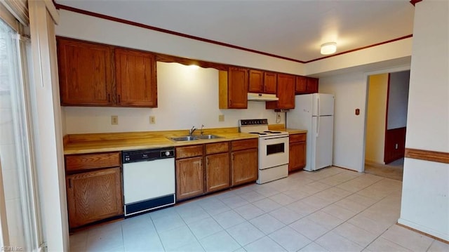 kitchen with white appliances, light countertops, a sink, and under cabinet range hood