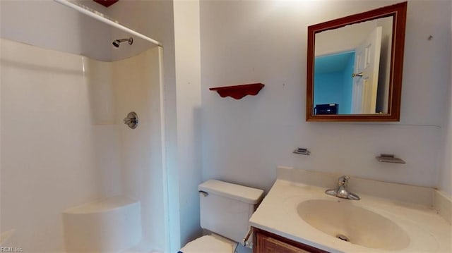 bathroom with toilet, walk in shower, and vanity