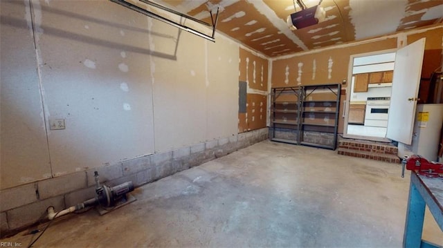 garage with water heater and a garage door opener