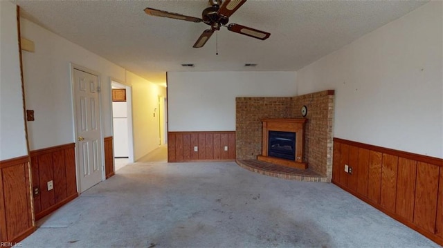 carpeted living room featuring wainscoting and wooden walls