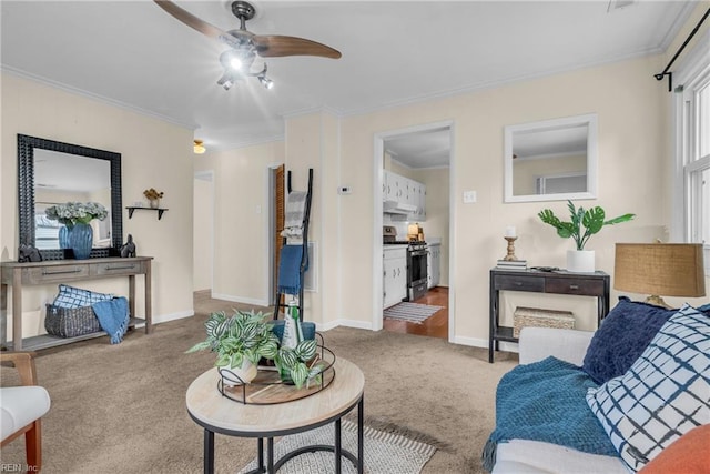 living room with crown molding, ceiling fan, and light carpet