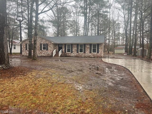 single story home with an outbuilding and a garage