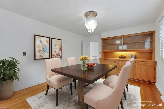 dining area featuring a chandelier and light wood-type flooring