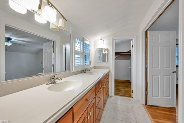 bathroom featuring vanity, lofted ceiling, tile patterned floors, and ceiling fan