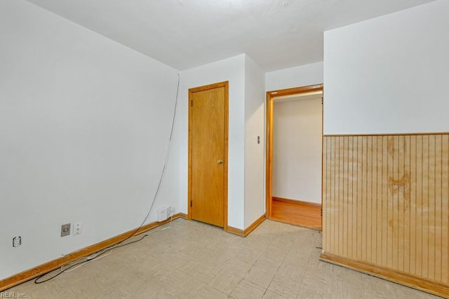 empty room featuring wood walls