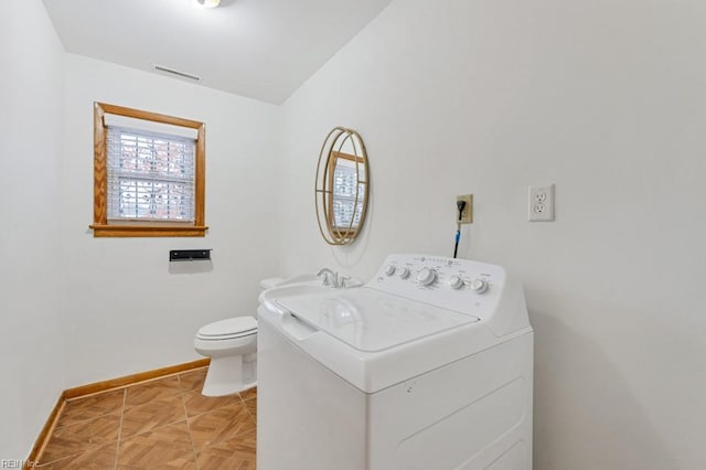 bathroom featuring washer / clothes dryer, vanity, parquet floors, and toilet