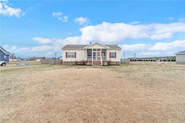 view of front of home with covered porch and a front lawn