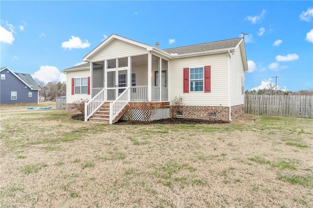 back of house with a sunroom and a lawn