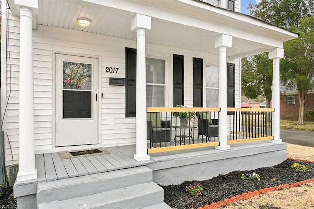 view of exterior entry with covered porch