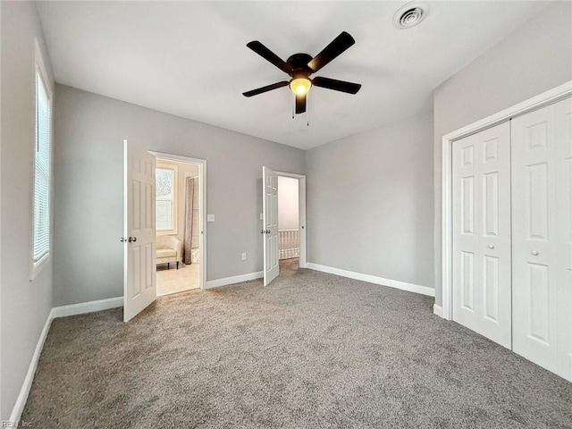 unfurnished bedroom with carpet floors, ceiling fan, and a closet