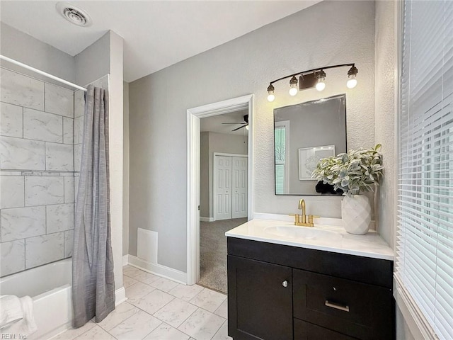 bathroom featuring ceiling fan, shower / tub combo with curtain, and vanity