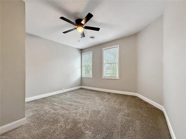 carpeted spare room with ceiling fan