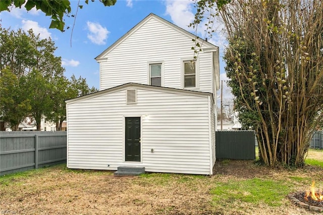 rear view of house featuring a yard