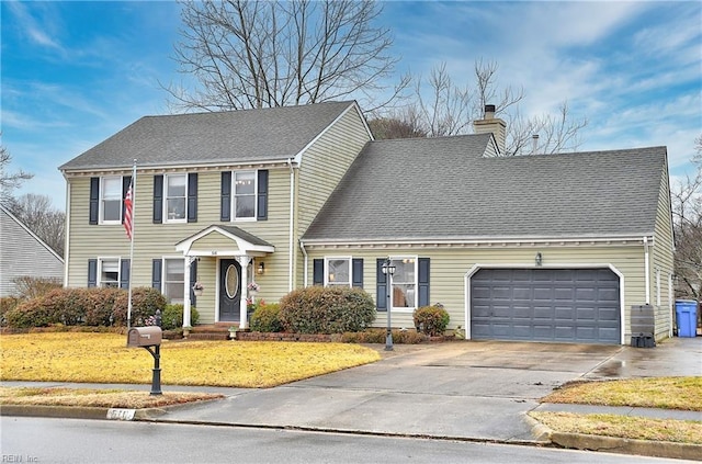 view of front facade featuring a garage and a front lawn