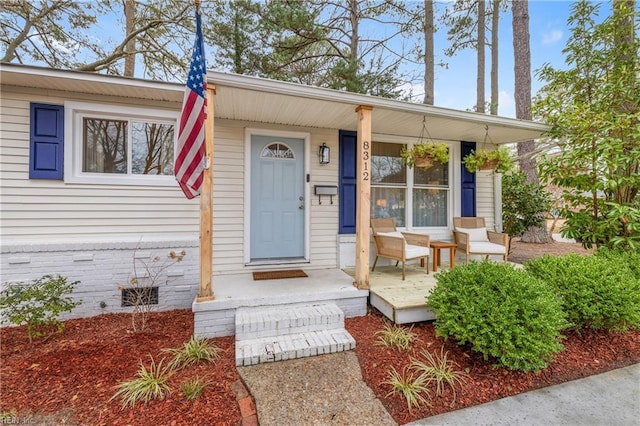 view of exterior entry featuring a porch