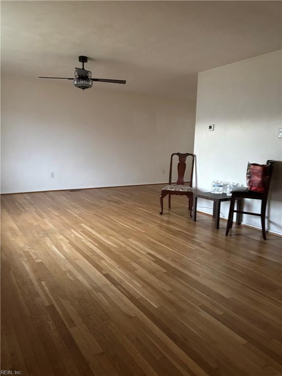 unfurnished room featuring wood finished floors and a ceiling fan