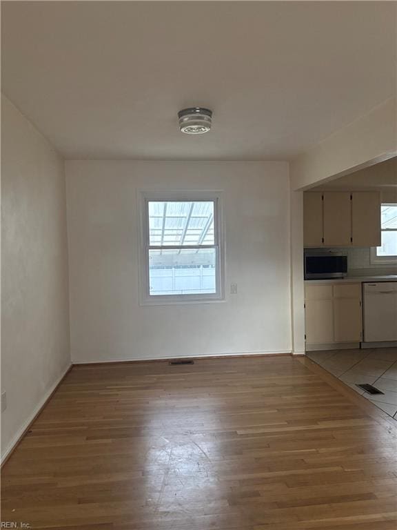 unfurnished dining area featuring light wood finished floors