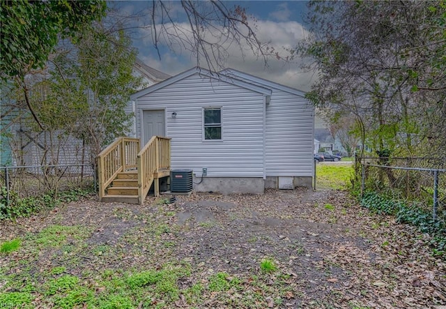 rear view of house featuring central AC unit