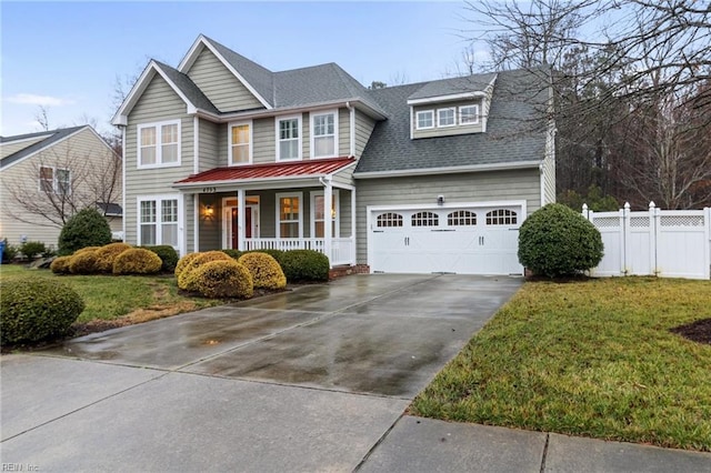 view of front of home with a porch, a garage, and a front lawn