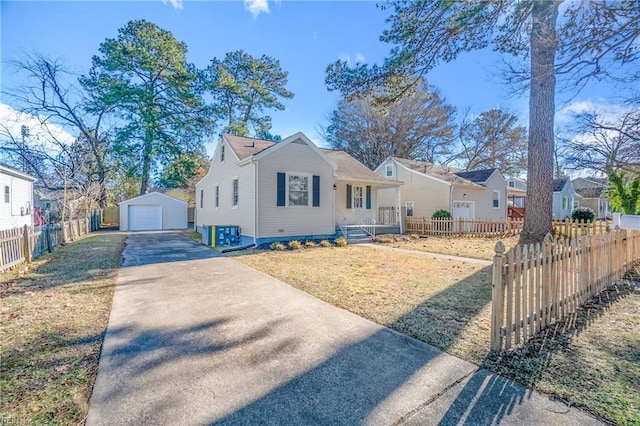 view of front of home with a garage and an outbuilding