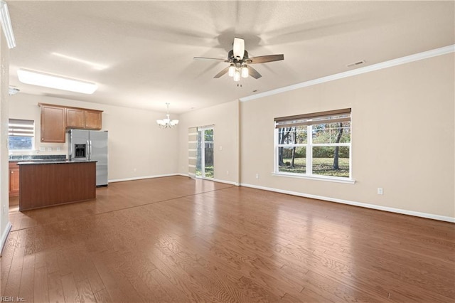 unfurnished living room with crown molding, dark wood-type flooring, and ceiling fan with notable chandelier