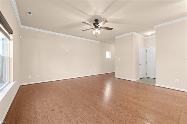 empty room with crown molding, ceiling fan, and light wood-type flooring