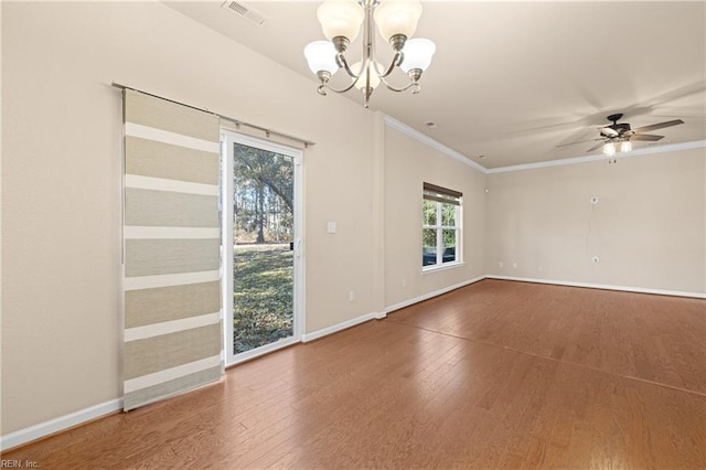 spare room featuring crown molding, wood-type flooring, and ceiling fan with notable chandelier