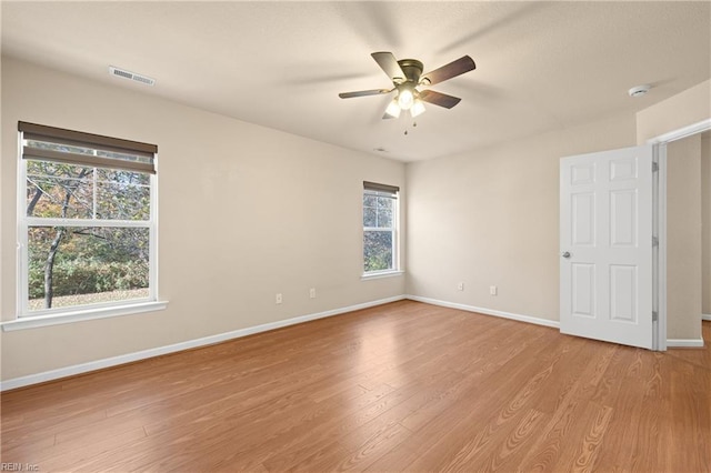 spare room with ceiling fan and light wood-type flooring