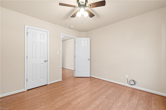 unfurnished bedroom with ceiling fan and light wood-type flooring