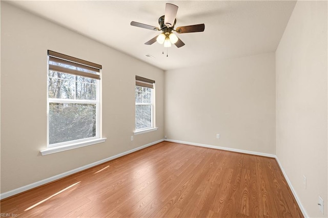 spare room with ceiling fan and light wood-type flooring