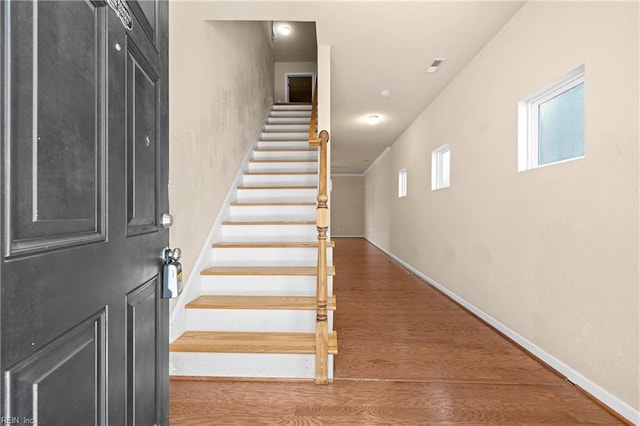 stairs featuring wood-type flooring