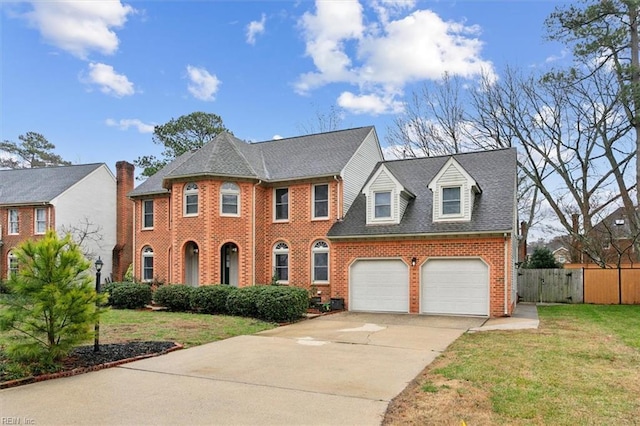 view of front of property with a garage and a front lawn