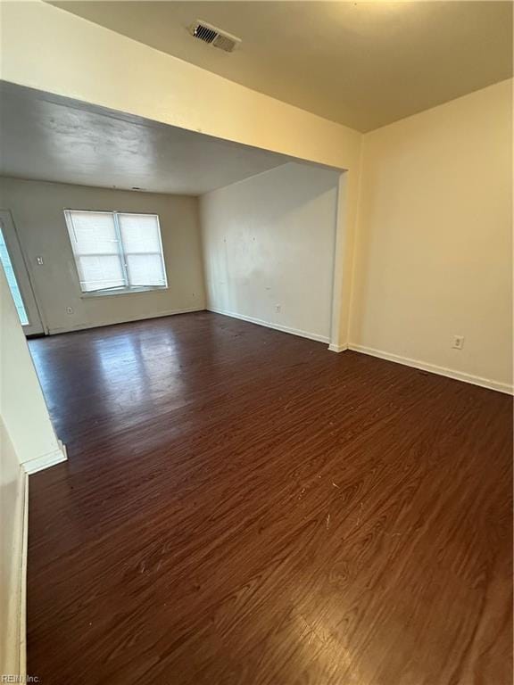 spare room with dark wood-type flooring